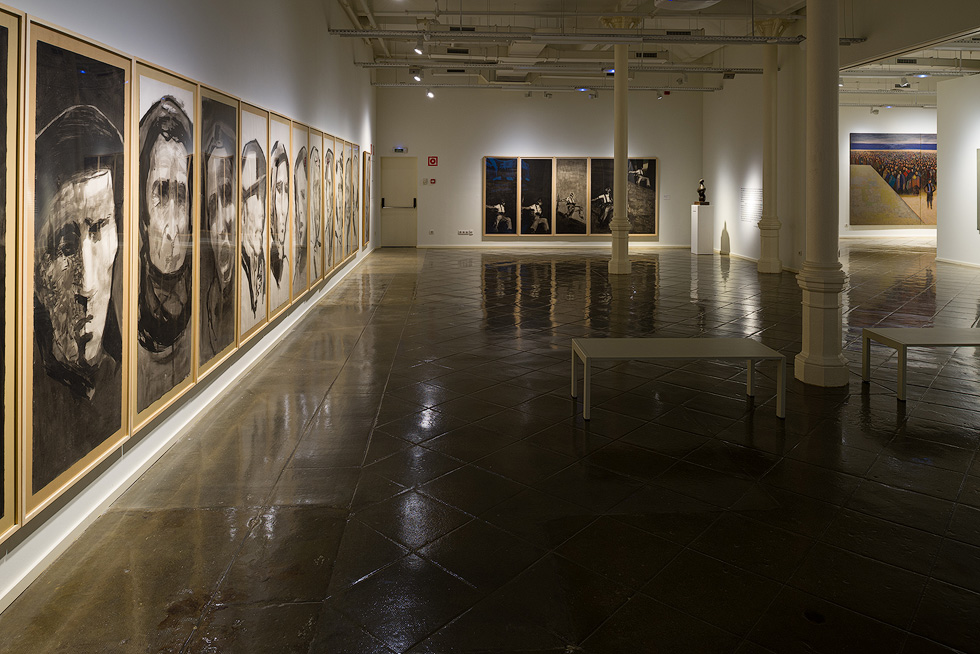 Art gallery with a series of large portrait paintings on the left and additional artwork in the background.