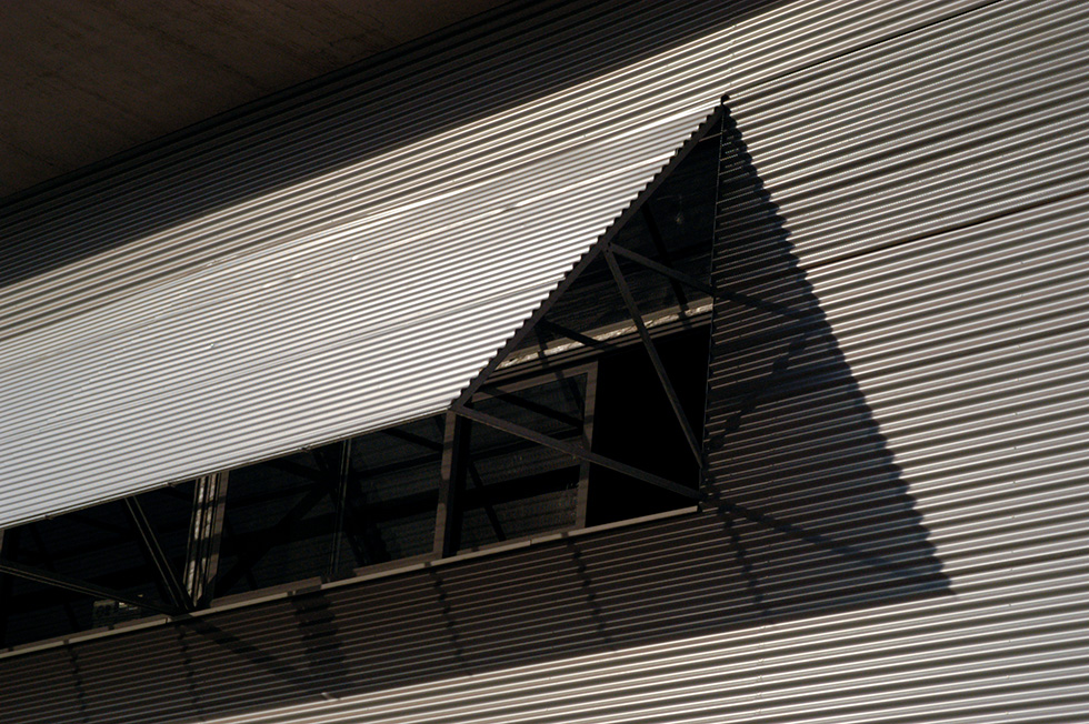 Close-up of Fontajau High School's exterior showing the detailed metal cladding and a triangular window feature.