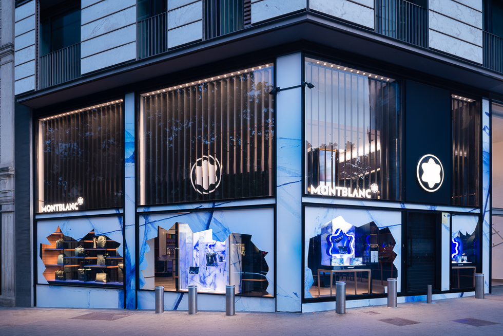 Exterior view of a Montblanc store with glacier-themed window displays and branding.