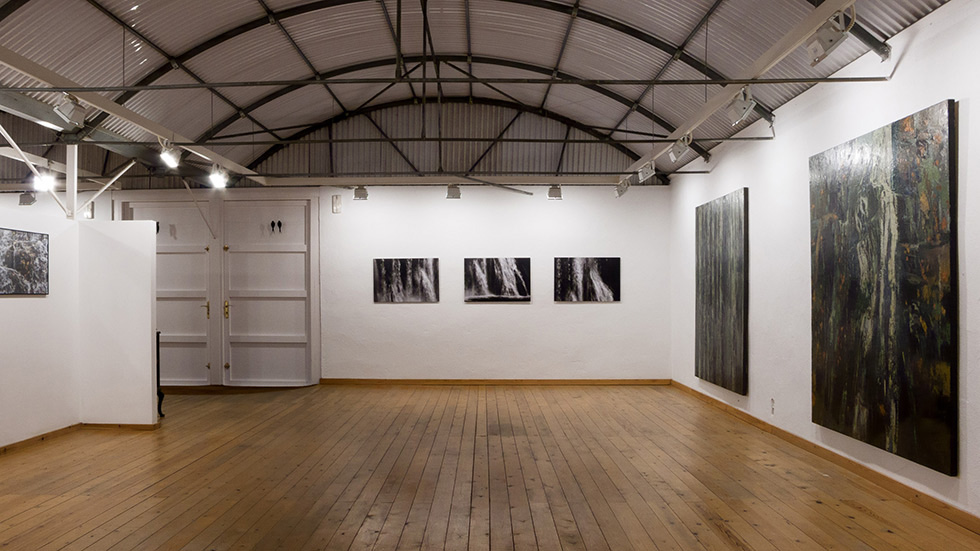 Exhibition space with large and medium artworks on display.